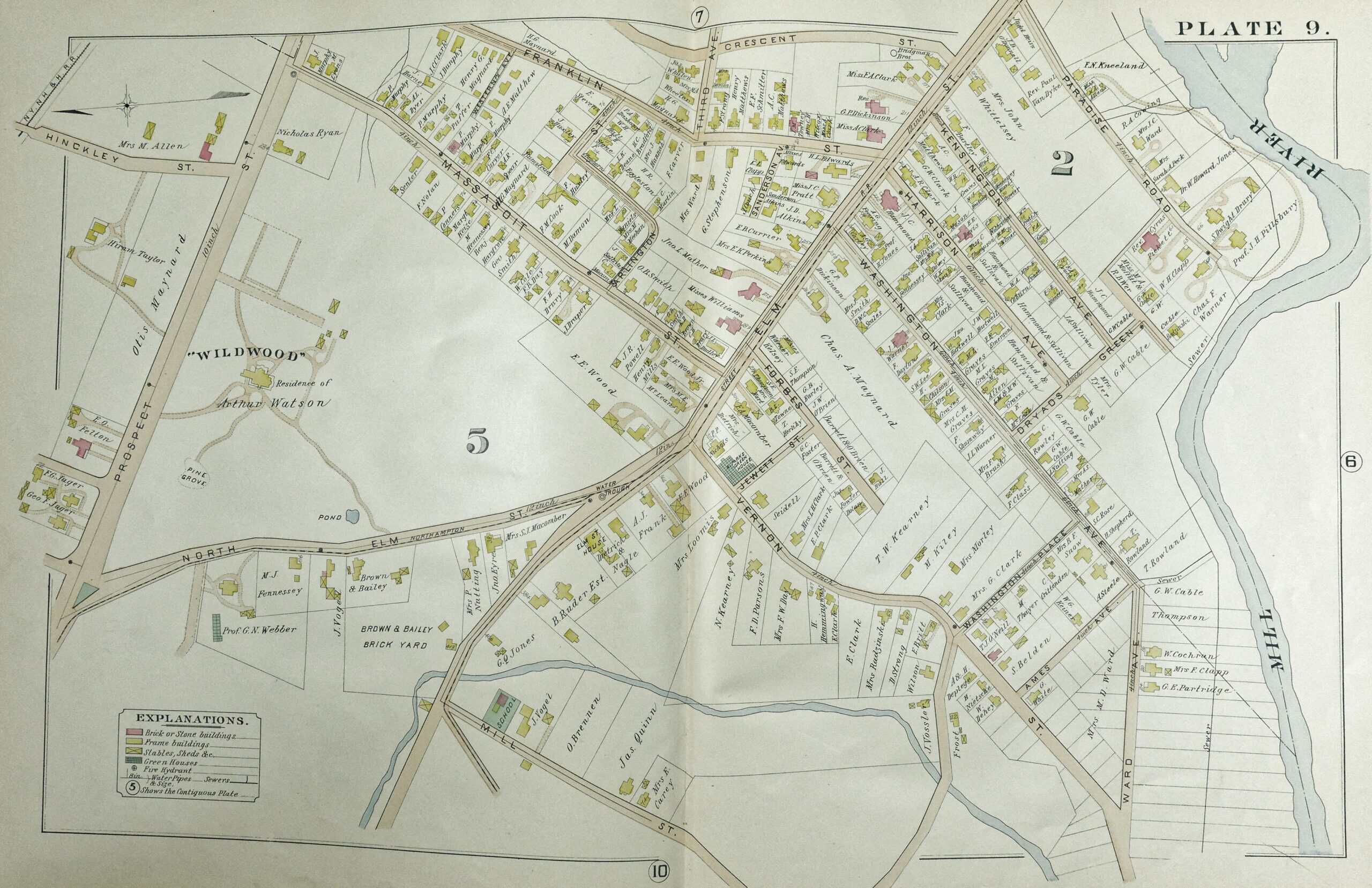 Historical atlas map of a section of Northampton, labeled "PLATE 9." It details property lines, names of landowners, and streets. The Mill River bends along the right edge of the map. Major streets include Prospect Street, Elm Street, Massasoit Street, and Washington Avenue. Large land parcels are labeled, including "WILDWOOD," which takes up almost 1/4th of the map.
