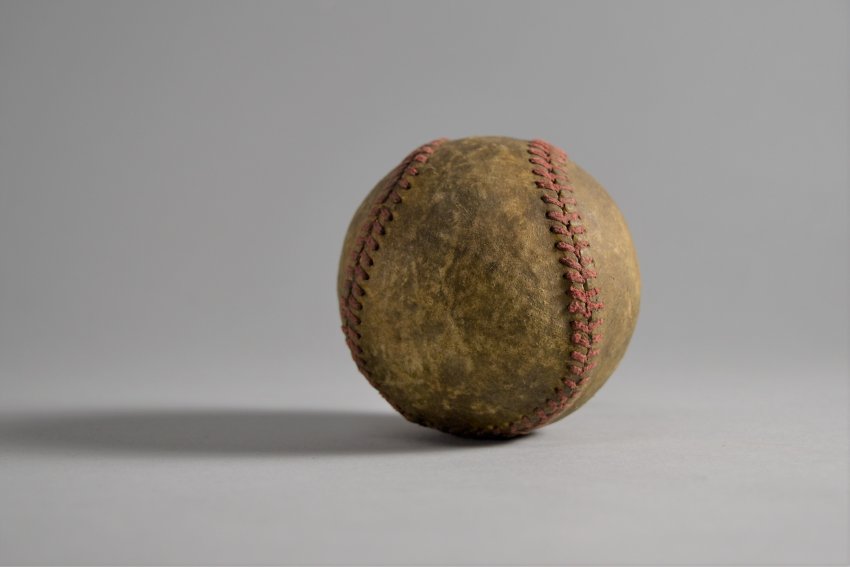 Color photo of an old baseball with red stiching