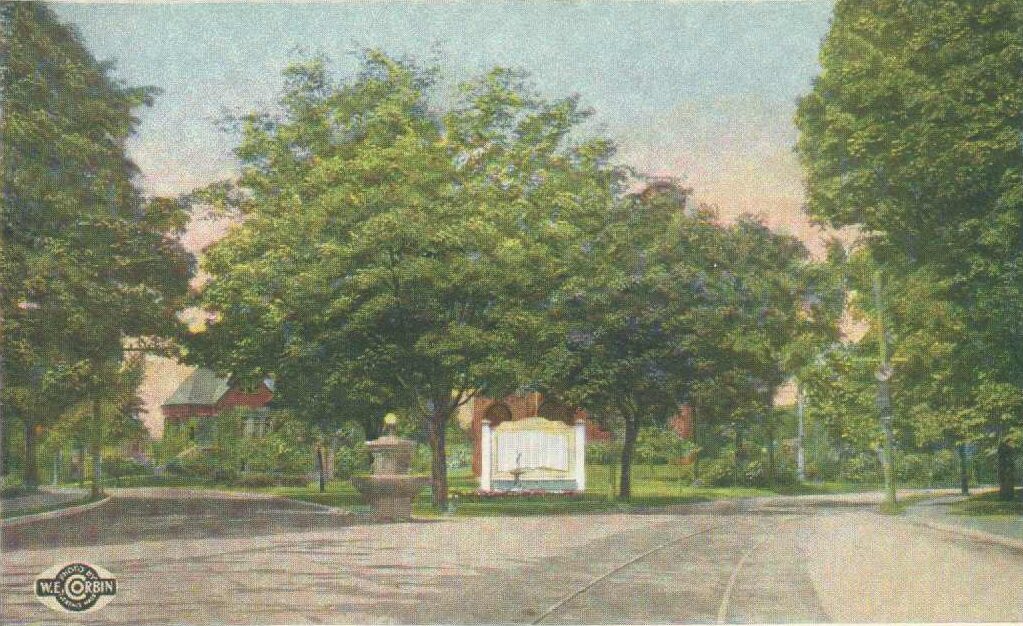 	
Colortone postcard, upper left reads "Maine Memorial Fountain and Park, Florence, Mass." Lower left emblem reads "Photo by W.E. Corbin, Florence, Mass." The image shows a water fountain surrounded by trees, with a white sign behind it.