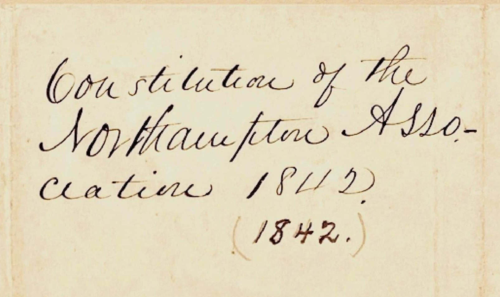 Image of title of document: "Constitution of the Northampton Association 1842" in cursive handwritten script. Underneath 1842, someone writes (different handwriting) "(1842)."
