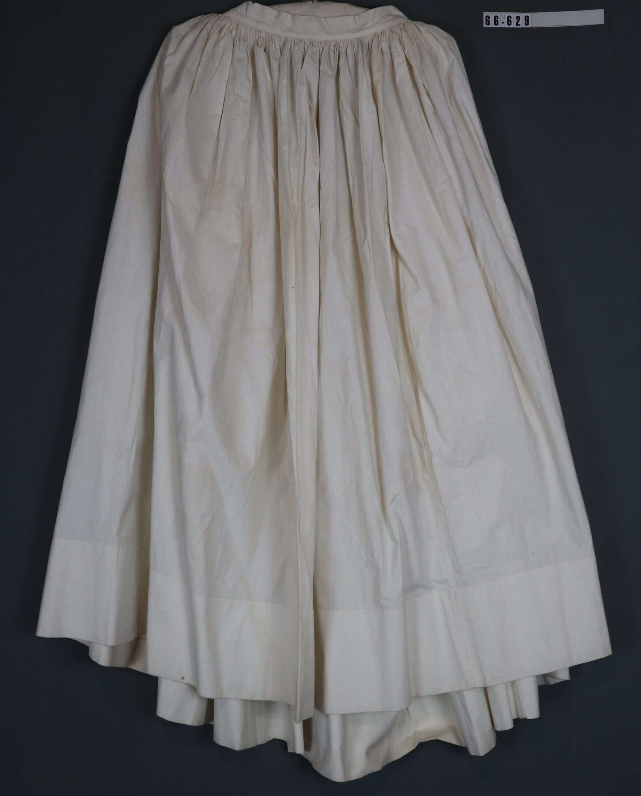 A white undergarment skirt, a bit yellowed from age and wear.