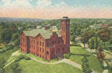 Colored aerial photograph or drawing of Cosmian Hall. The building is brick and has a large clock tower attached at the side. Surrounding the building is clear green grass and some bushes.