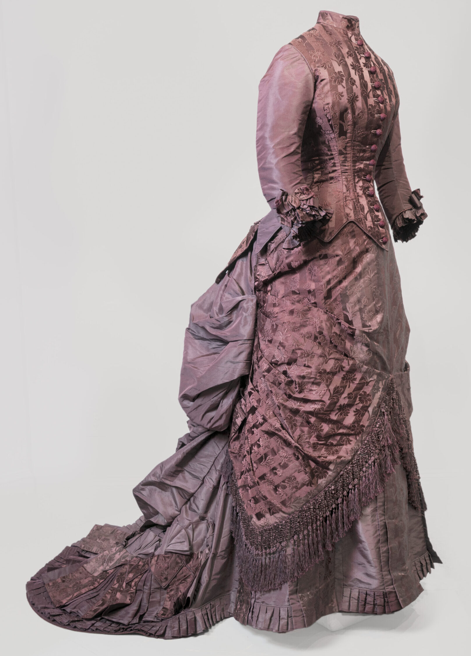 Side profile view of a purple layered dress with buttons.