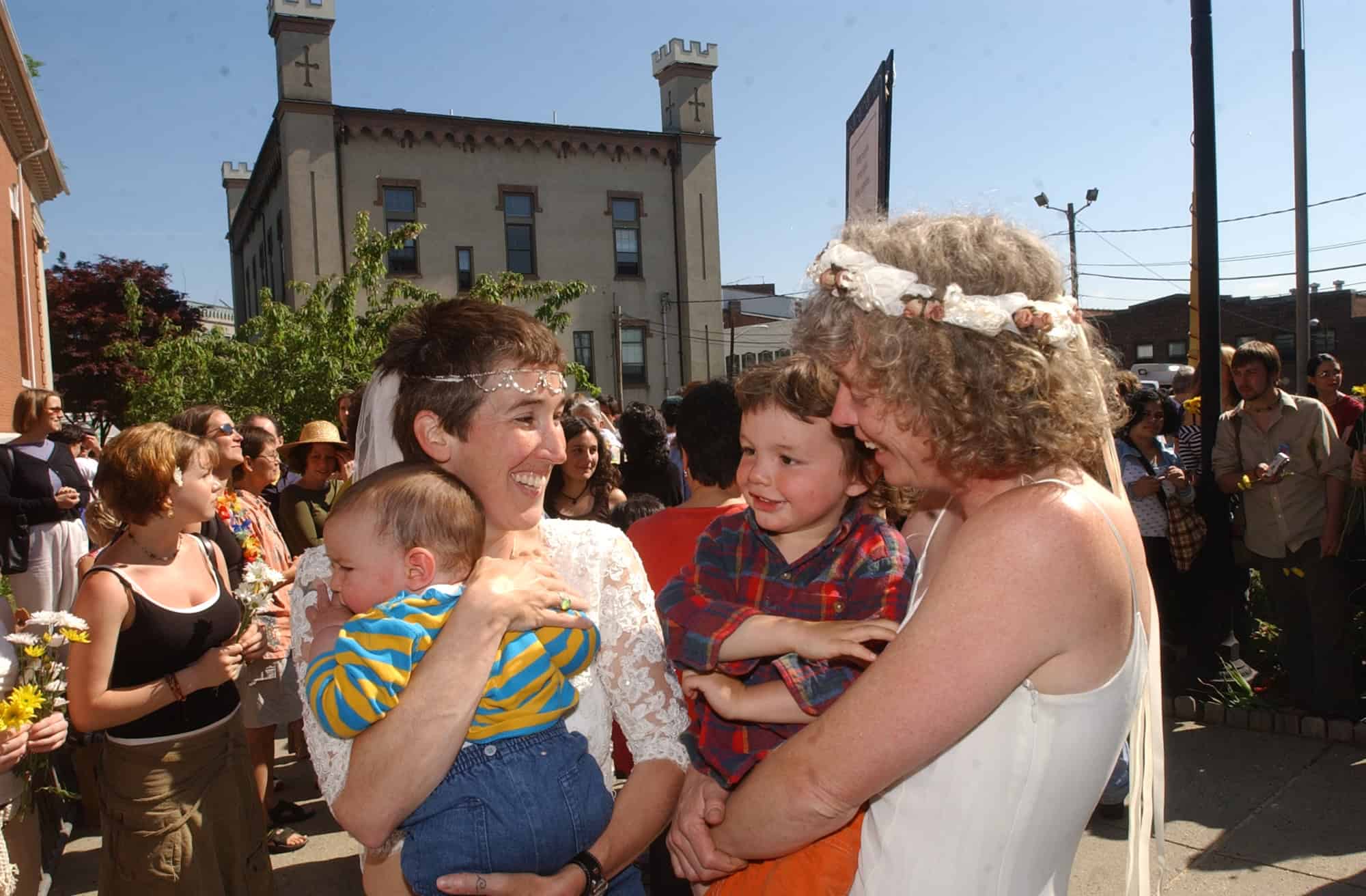 Women and children smile and gather in front of Northampton City Hall.