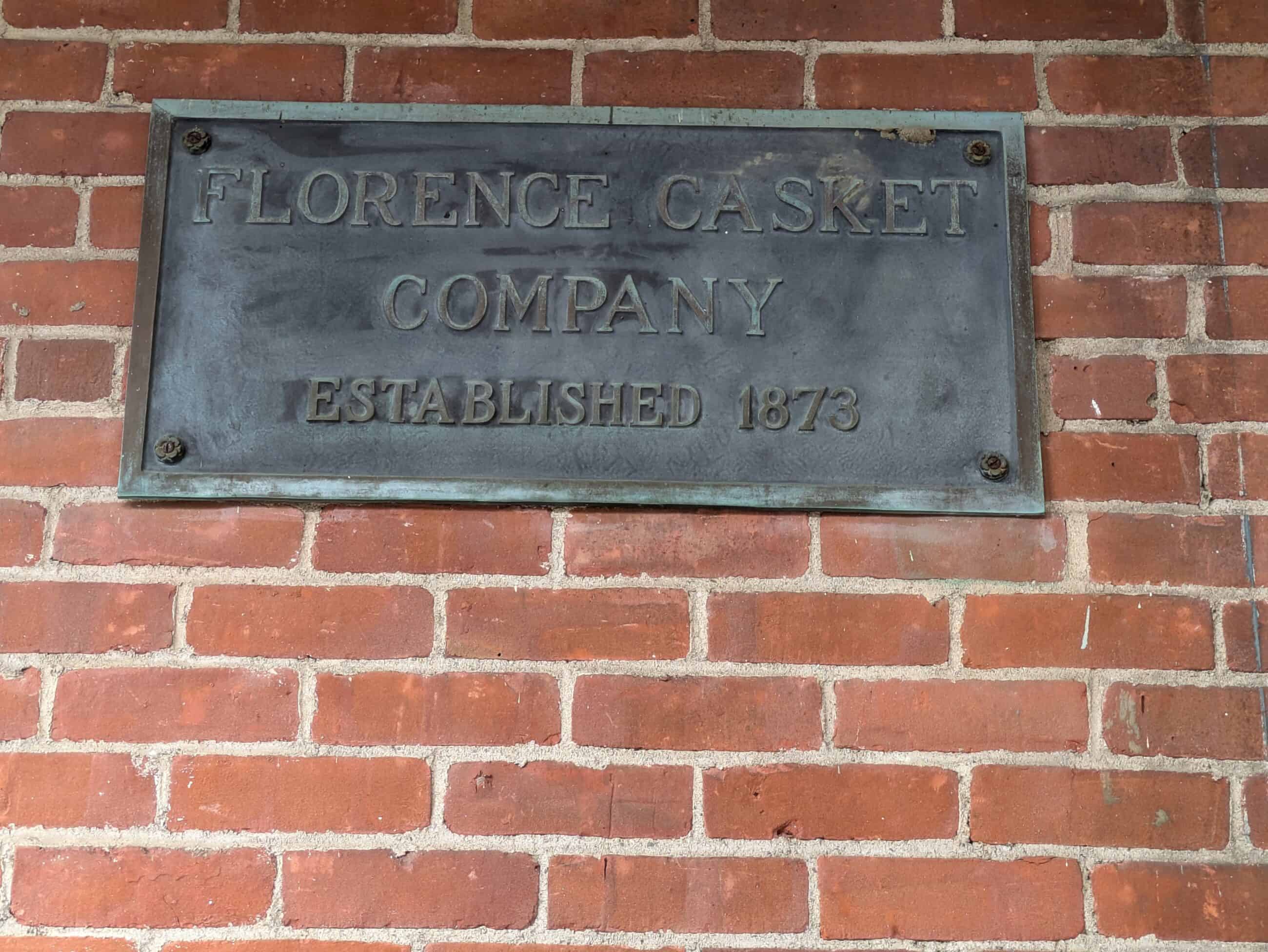 A plaque on the Florence Casket building. The plaque reads: "FLORENCE CASKET COMPANY / ESTABLISHED 1873."