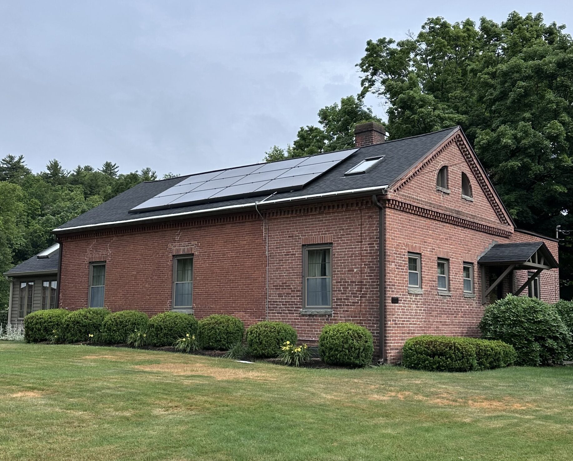 Photograph of old west farms school house. Red brick building.