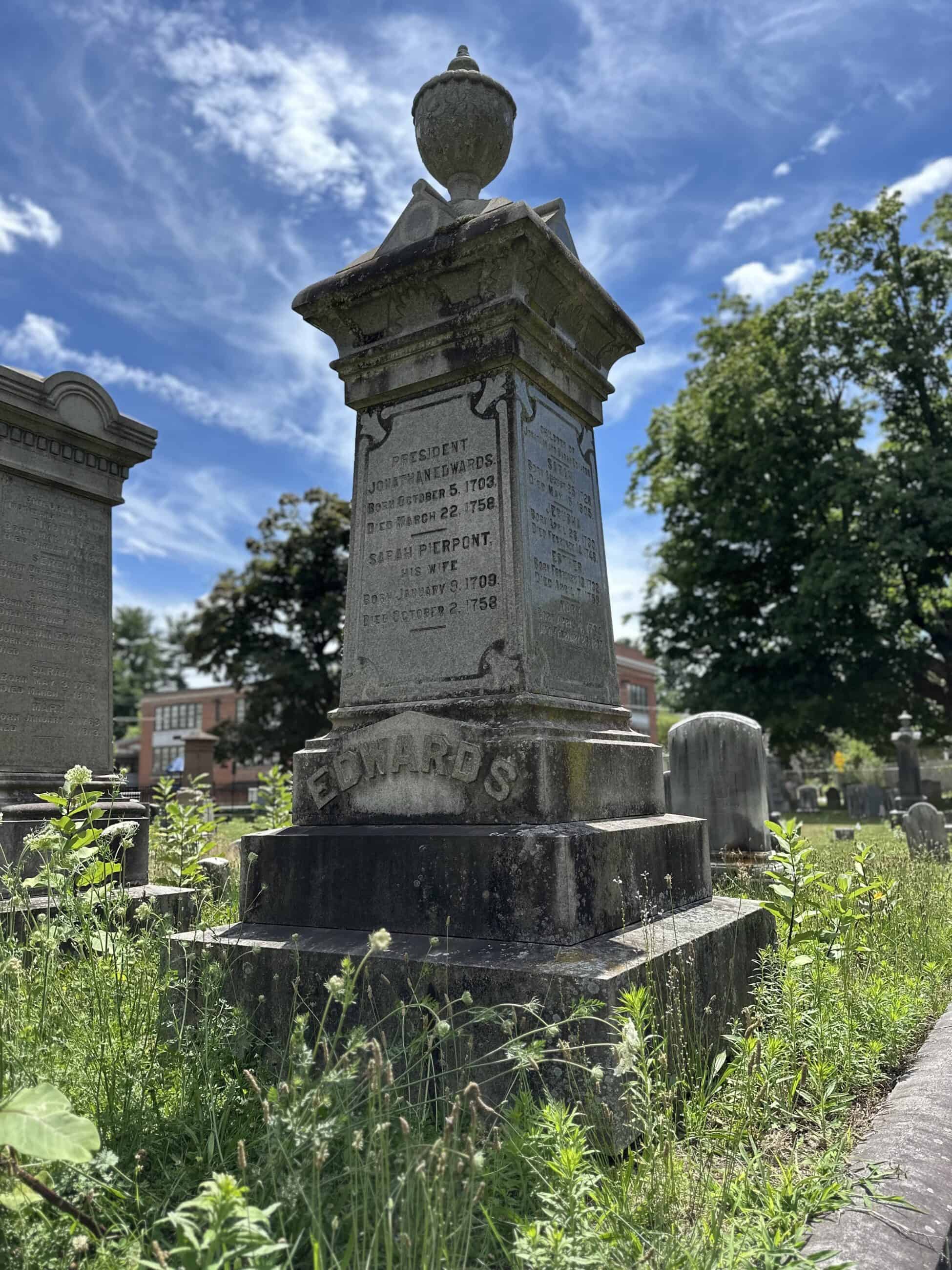 Photograph of one of the Edwards epitaphs in the Bridge Street Cemetery. The engraving has the birth and death dates for Jonathan Edwards, Sarah Pierpont, and more that are not fully legible on the side.