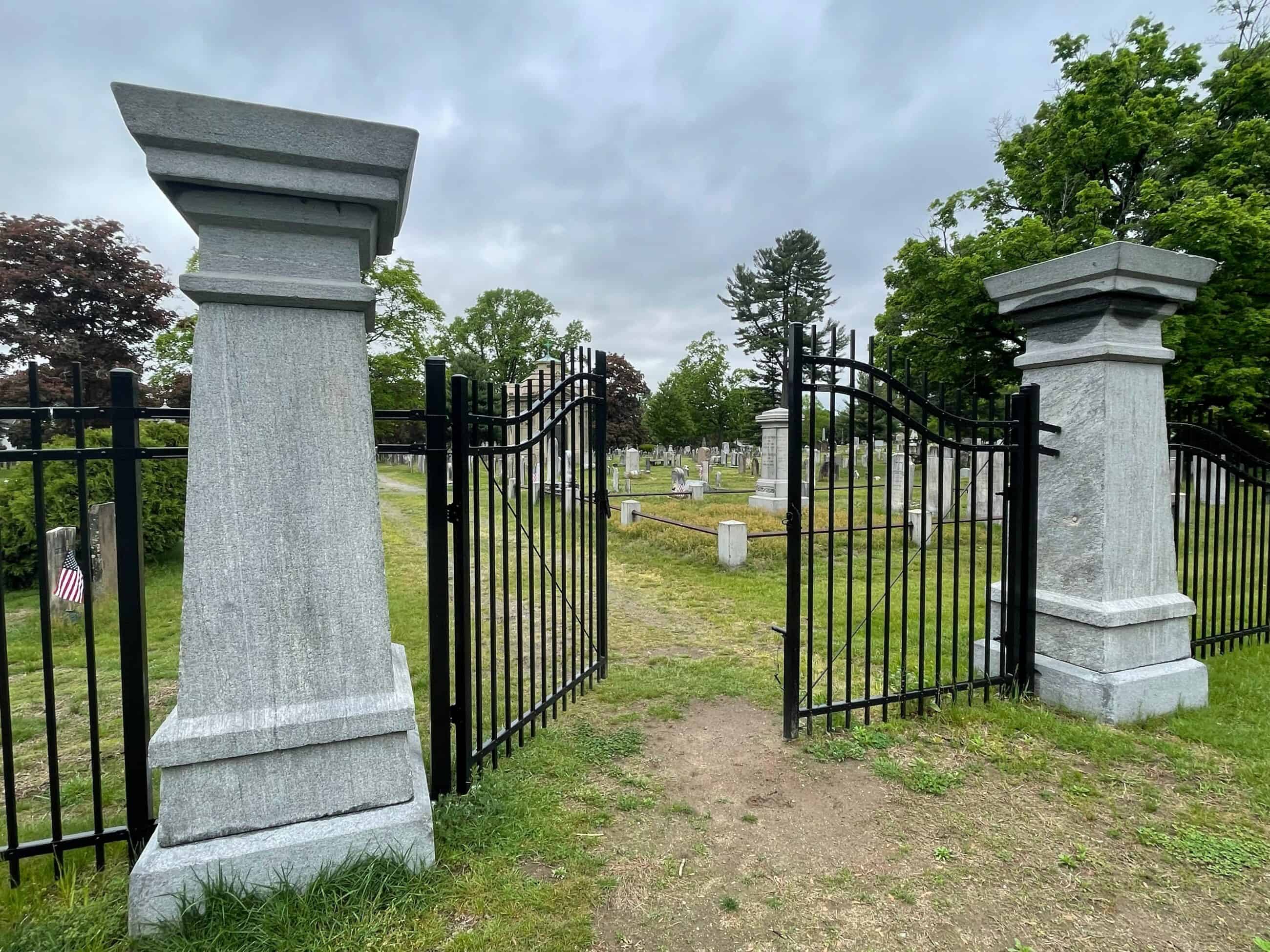 color photo of the gates of a cemetary, partially opened