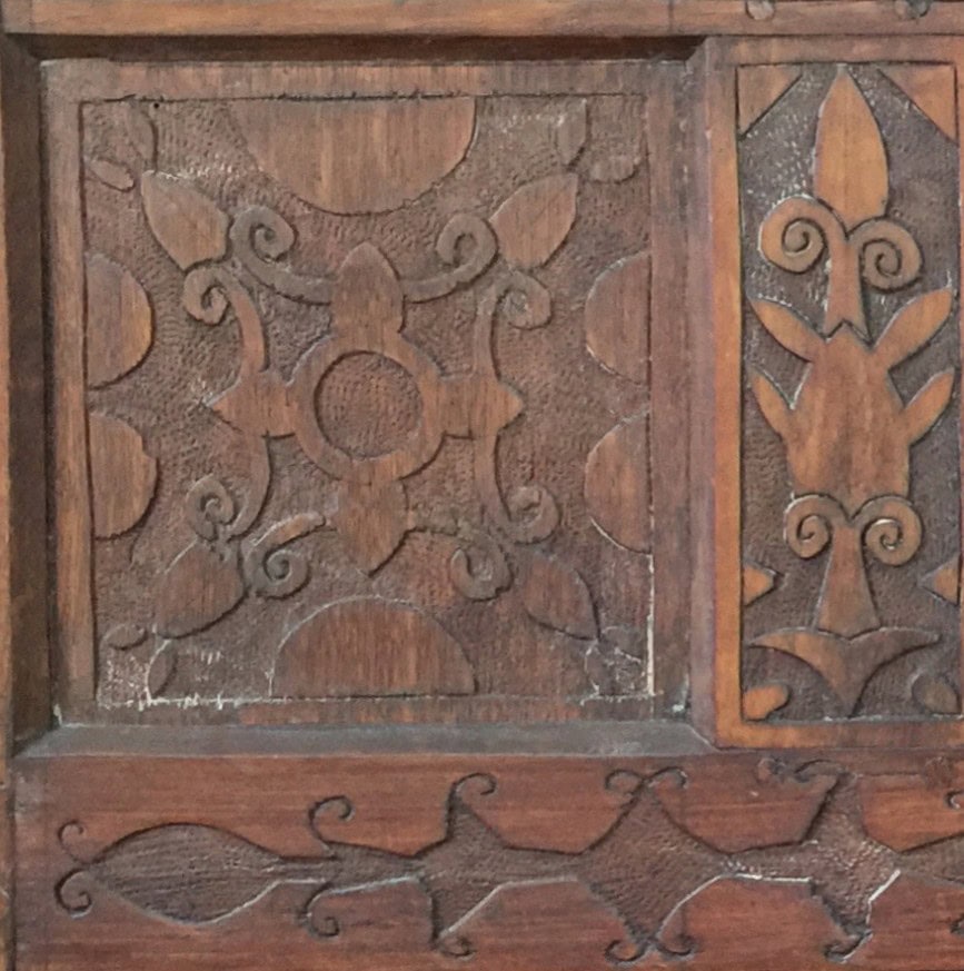 closeup of carved designs from one side of wooden chest