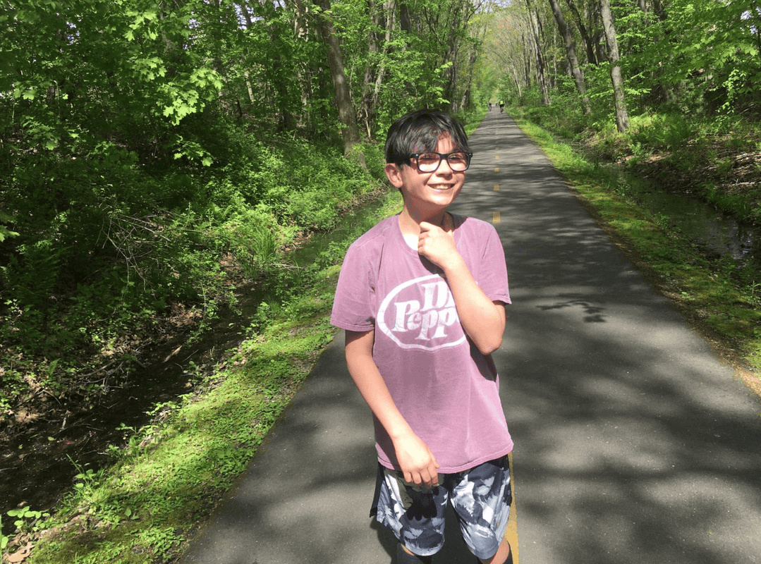 photo of young person on bike path