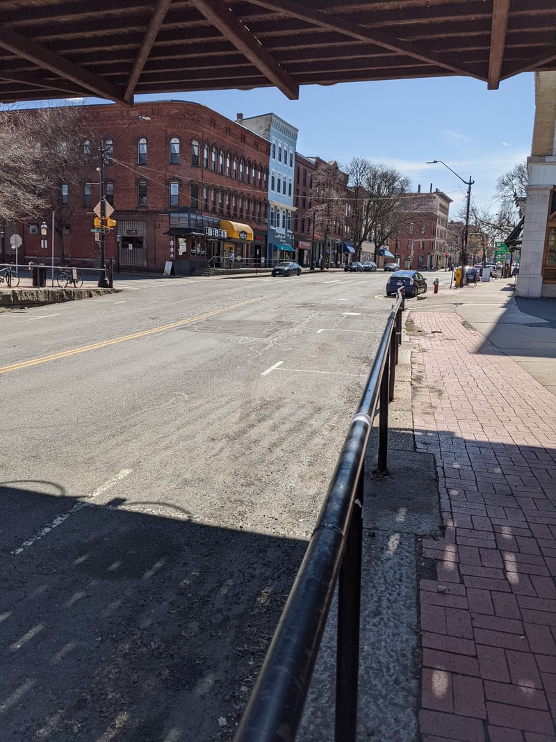 Photo of empty lower main street seen from under railroad bridge