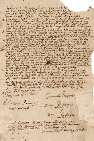 Photo of an old, handwritten document on brown paper, partially torn. The writing is too small to read, but it is clearly a legal document signed by several people, including 'Mingo' and 'Sue'.