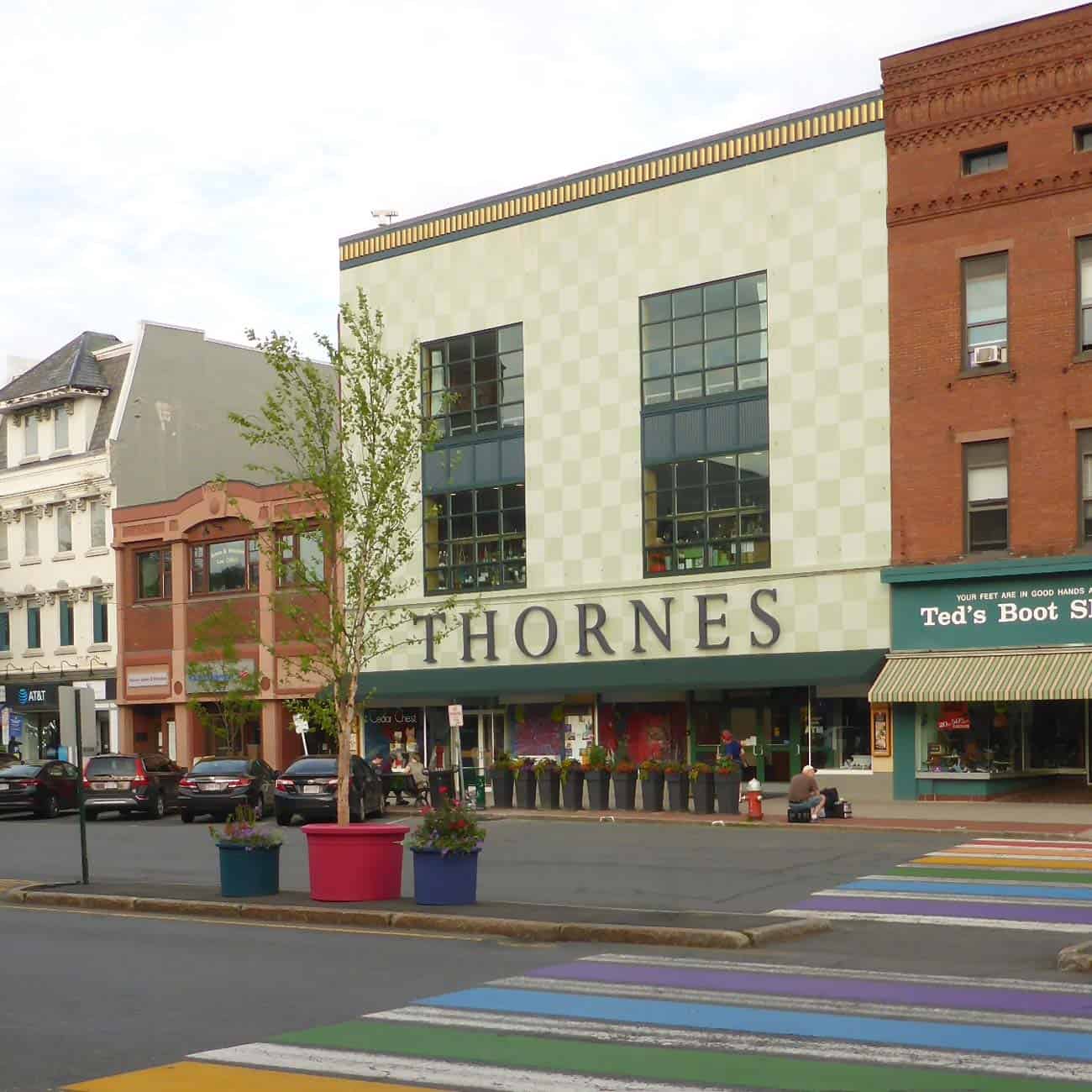 Storefront reading 'Thornes' with a rainbow crosswalk in the foreground.