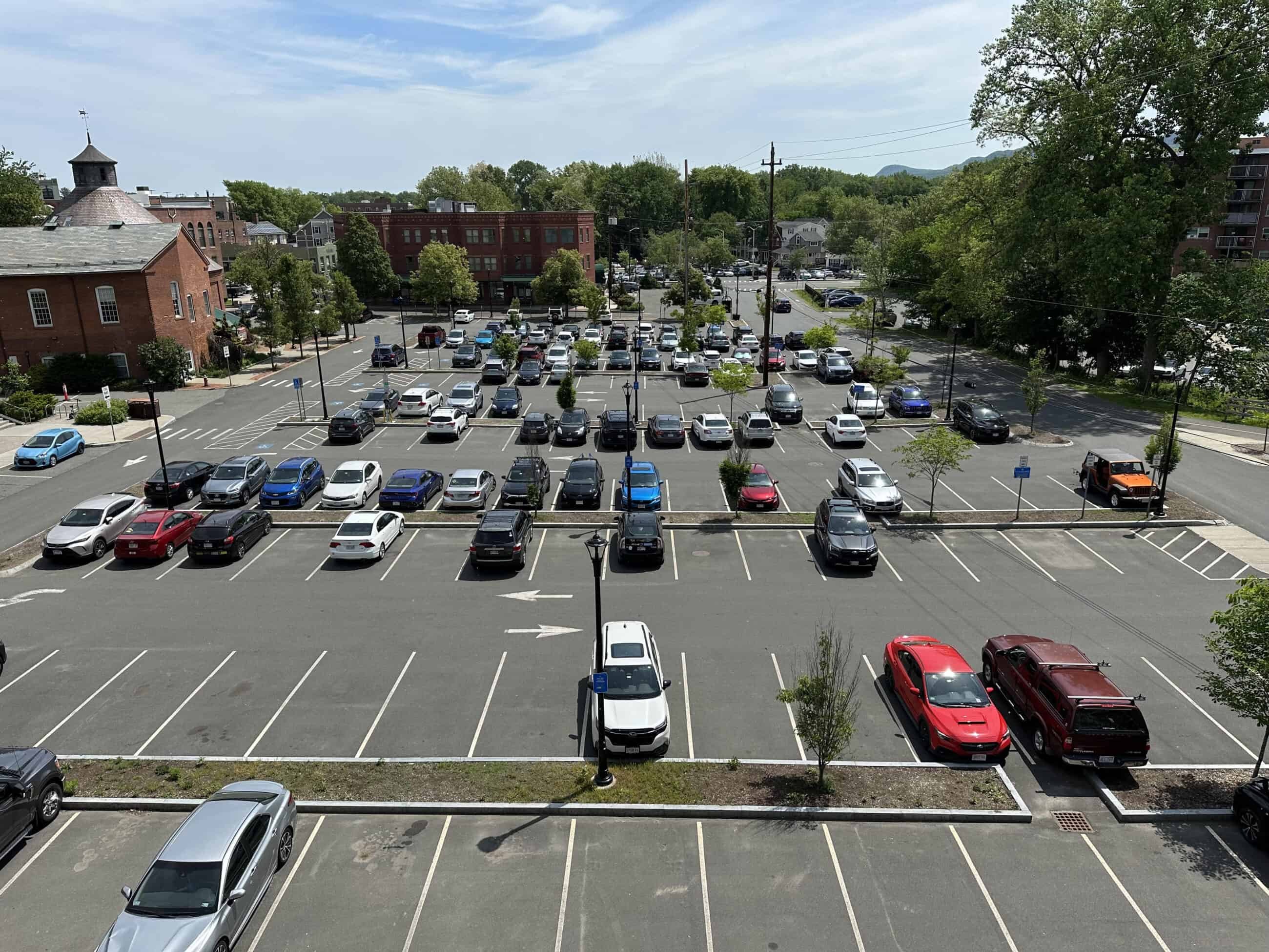 Photograph of a parking lot filled with cars.
