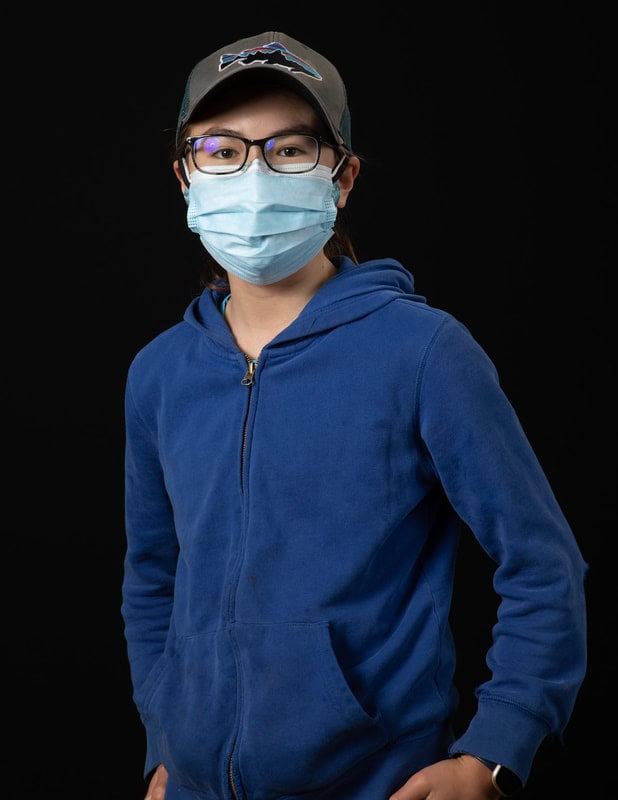 photo of young person wearing face mask and blue shirt