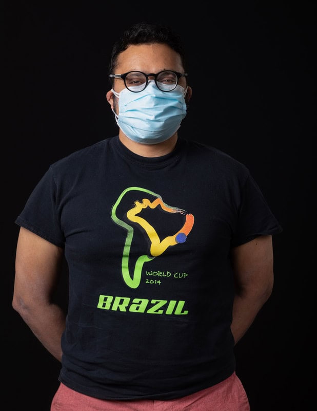 photo of person in face mask and black tshirt reading 'Brazil'