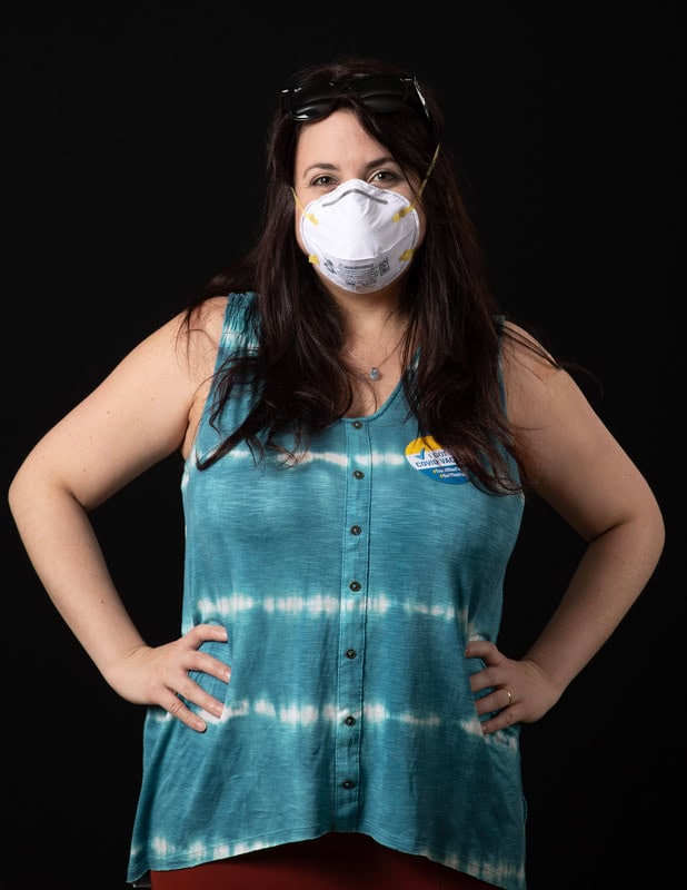 photo of person wearing face mask and blue shirt with 'I got my covid vaccine' sticker