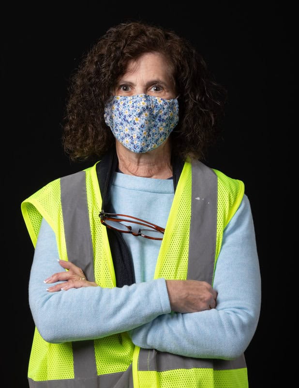 photo of person wearing face mask and a yellow vest