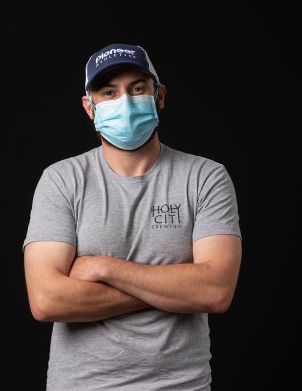 photo of person wearing face mask with arms crossed