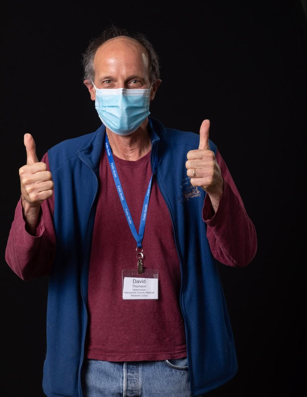 photo of person wearing face mask and blue vest