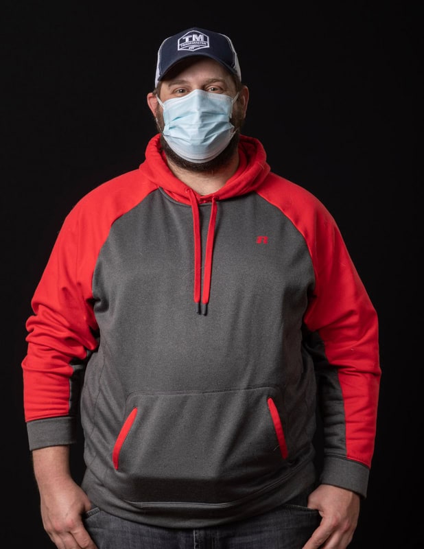 Photo of person wearing face mask and red sweatshirt
