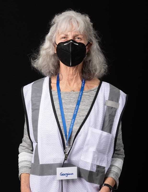 photo of person wearing face mask and white vest