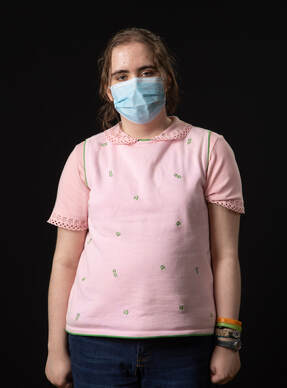 Photo of person wearing face mask and pink shirt