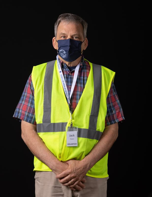 photo of person wearing face mask and a yellow vest