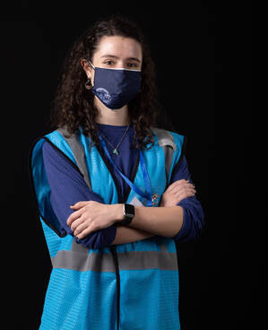 photo of person wearing face mask and blue vest