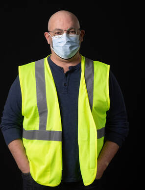 photo of person wearing face mask and a yellow vest