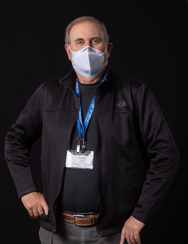 photo of person wearing face mask and name tag