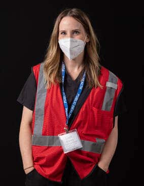 photo of person wearing face mask and red vest
