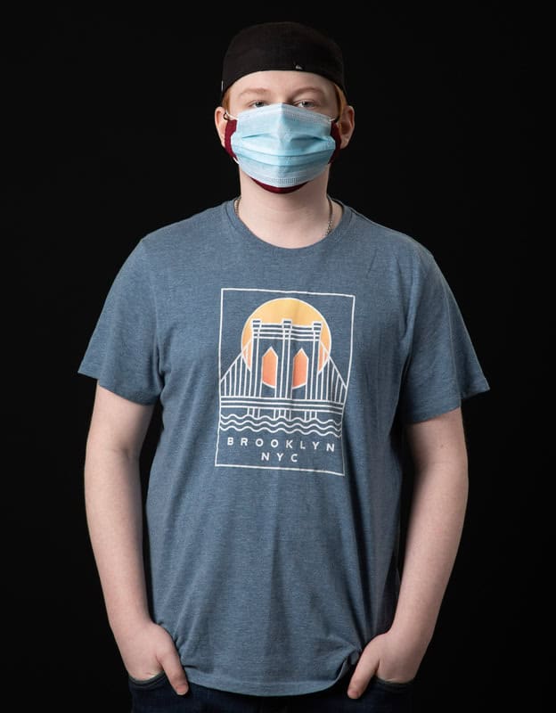 photo of person wearing face mask and t-shirt reading "Brooklyn NYC'
