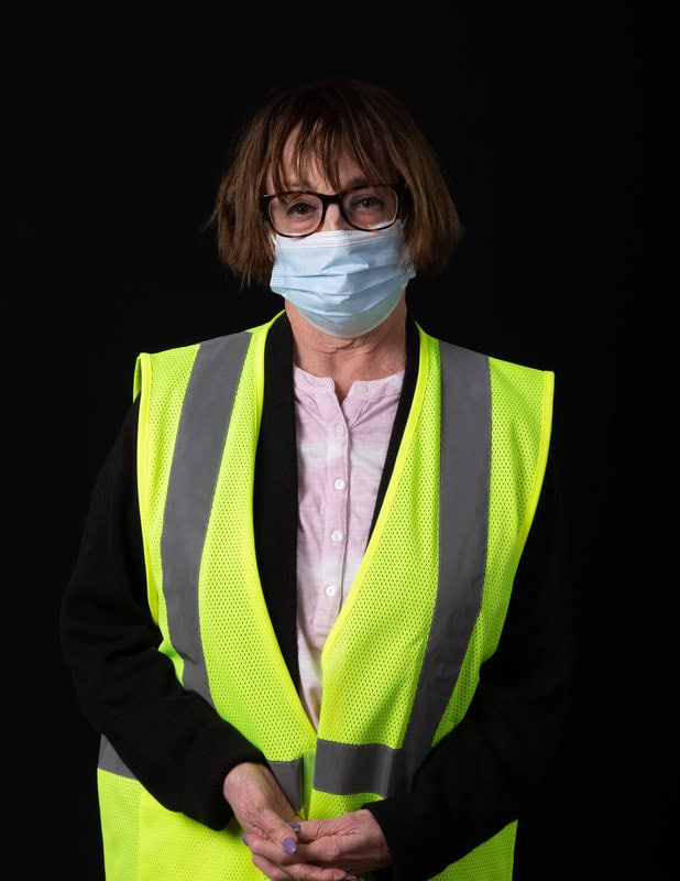photo of person wearing face mask and a yellow vest