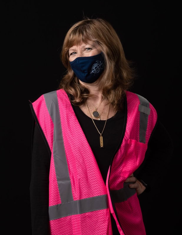 photo of person wearing face mask and pink vest