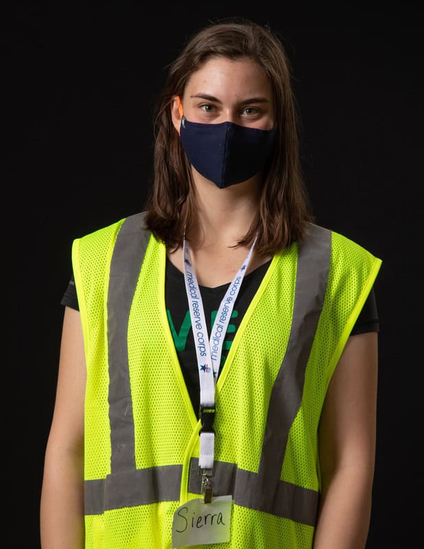 Photo of person wearing face mask and yellow vest