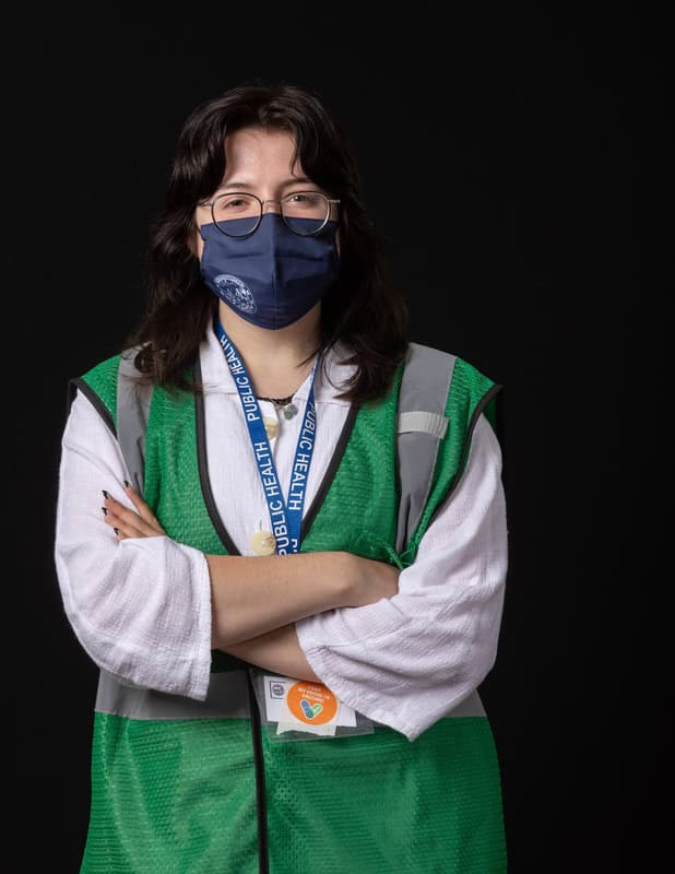 photo of person wearing face mask and green vest
