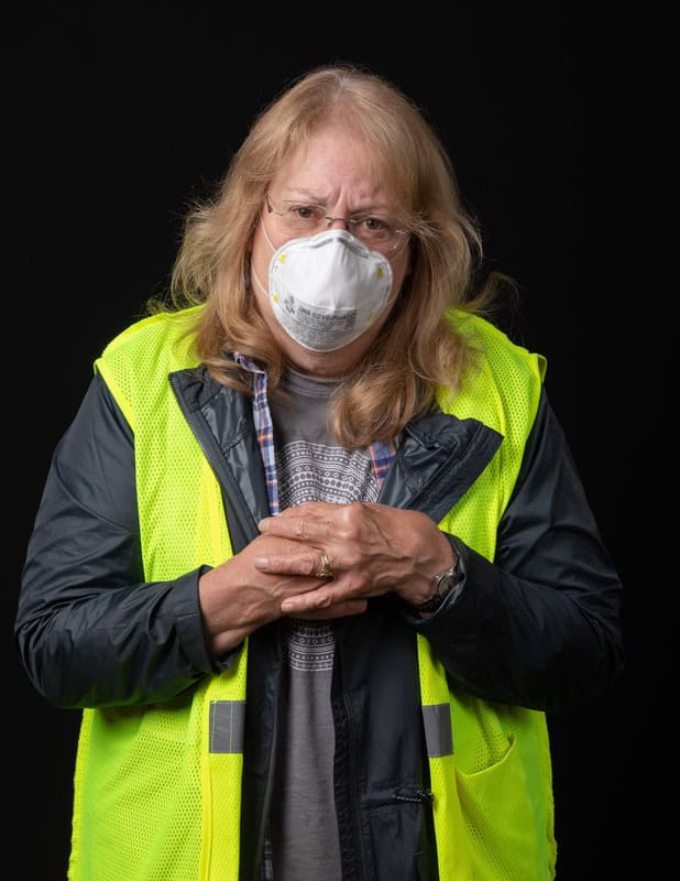 photo of person wearing face mask and a yellow vest