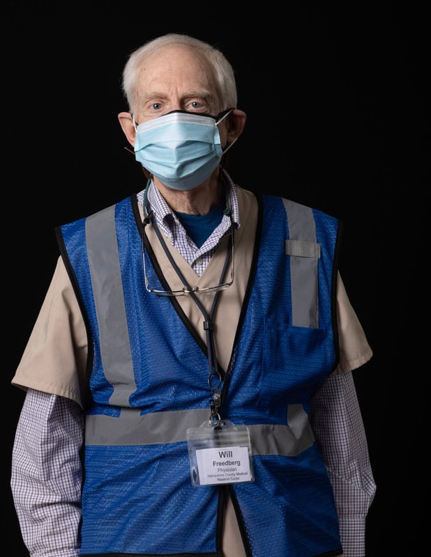 Photo of person wearing face mask and blue vest